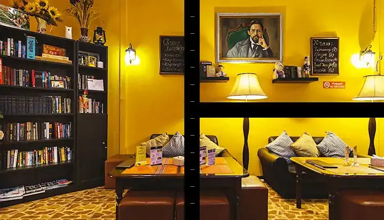 Chekhoff dining room: yellow walls, a tall bookcase, leather sofas, chalkboards and a framed portrait above the lamps