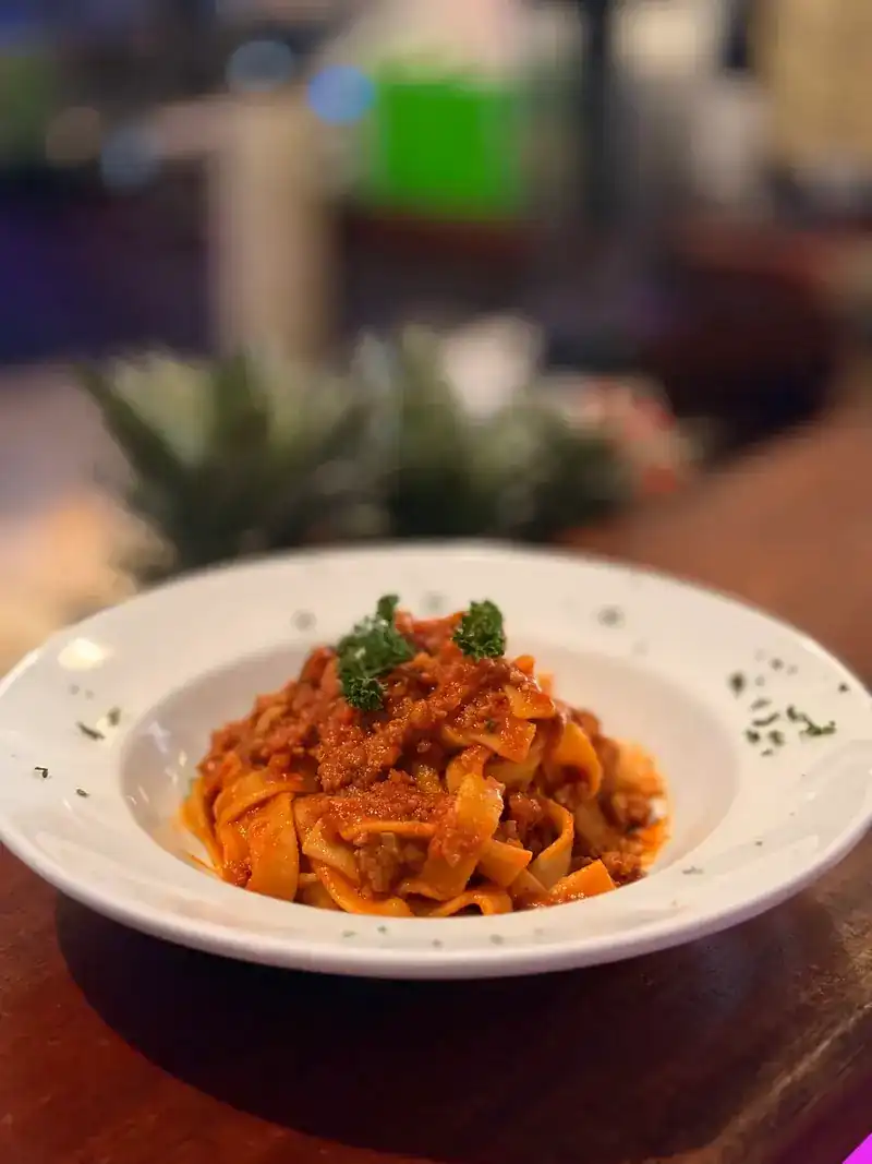 Tagliatelle in a red sauce, topped with parsley
