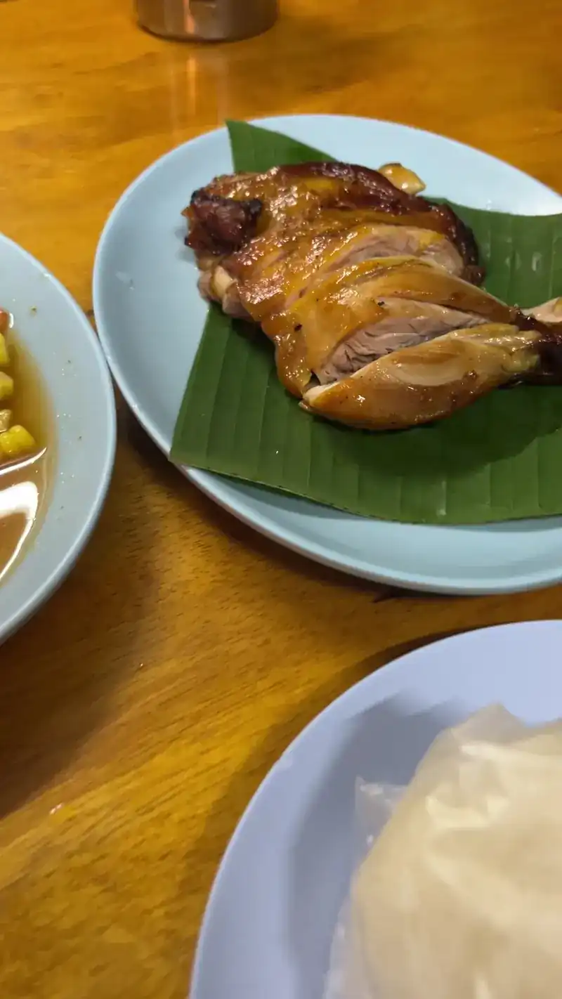 A golden chicken leg on a banana leaf