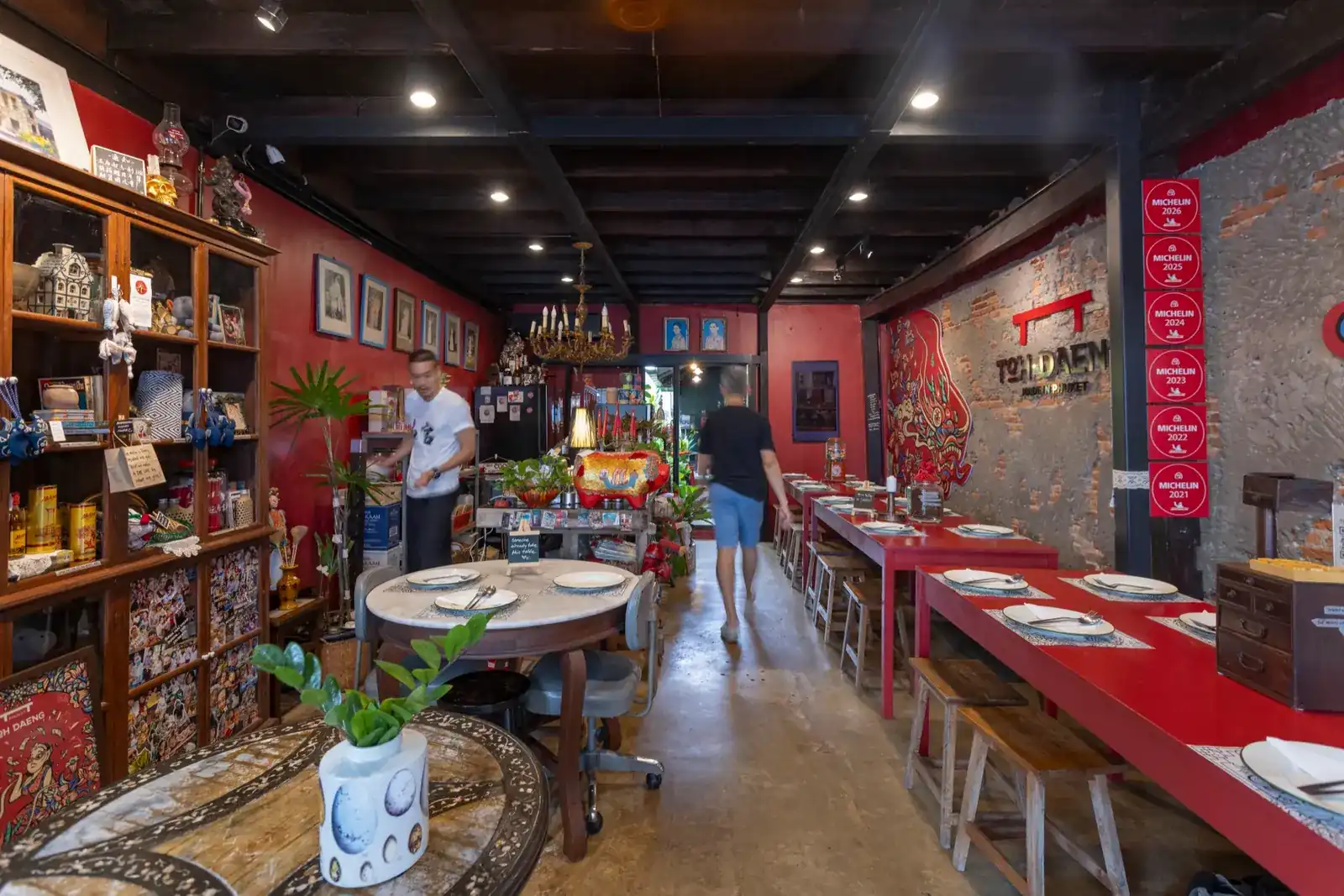 The long red communal tables inside the Old Town shophouse, set for lunch