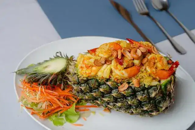 Fried rice with prawns and cashews served in a pineapple half