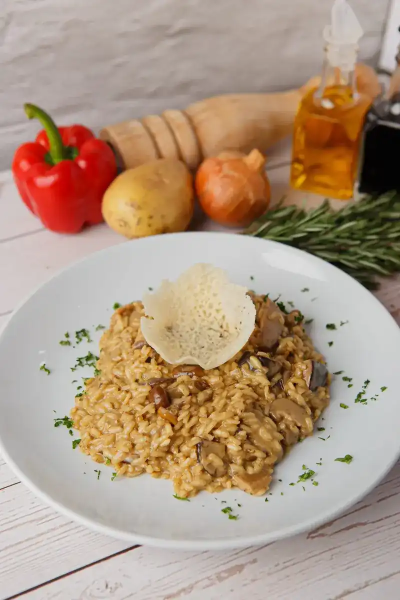 Mushroom risotto topped with a parmesan crisp