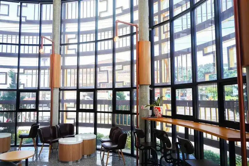 Window seats and a long oak counter along the glass wall