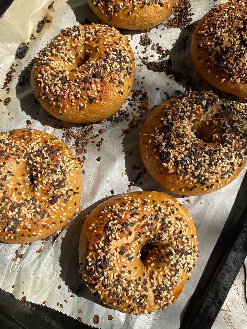 Everything bagels with sesame and seeds on a baking tray