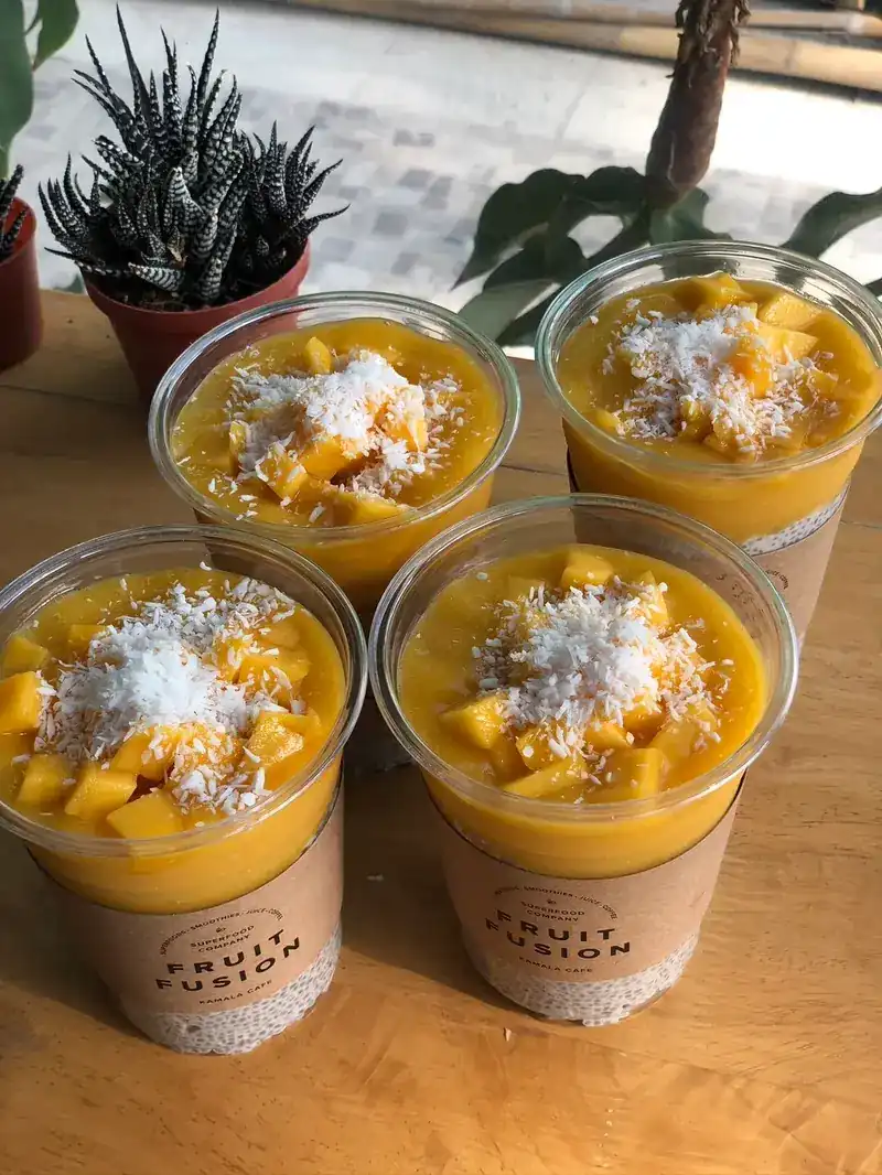 Four Fruit Fusion cups topped with mango and grated coconut