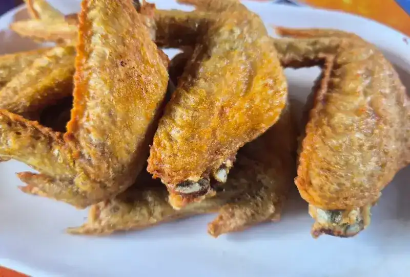A plate of golden fried chicken wings