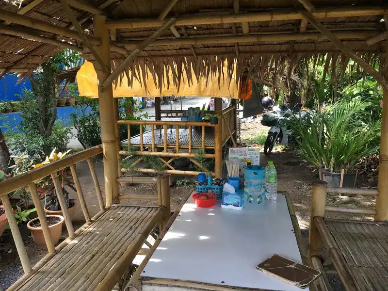 A bamboo hut with a table and benches in the shop's garden