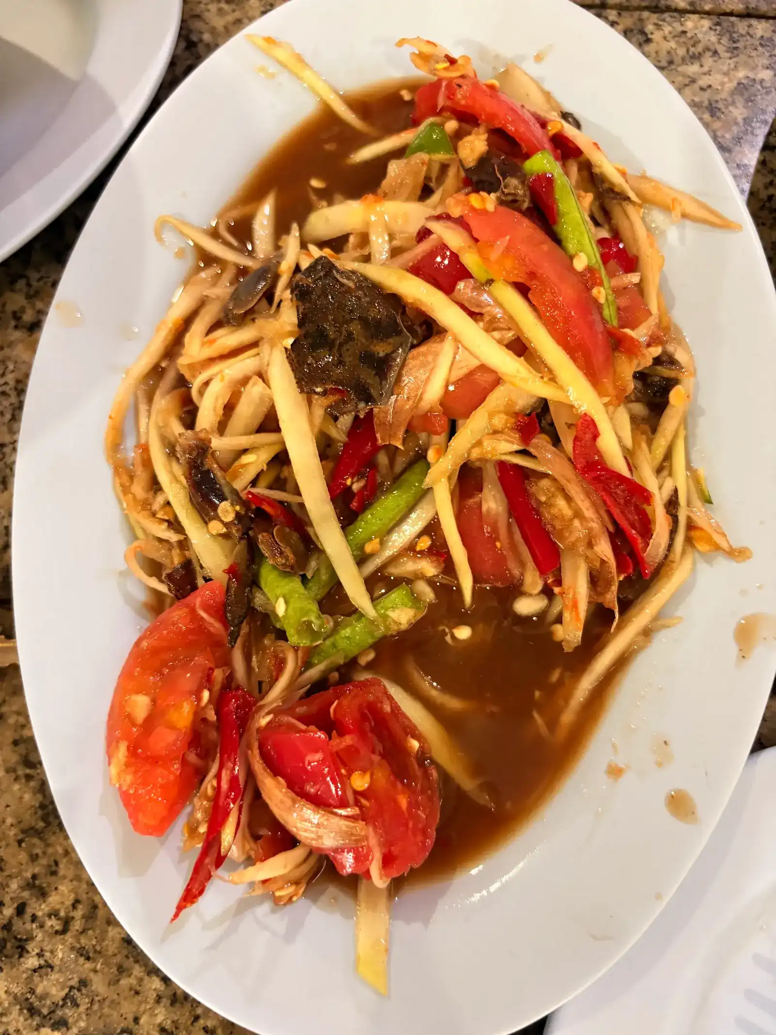 Papaya salad with salted crab, tomato, long beans and chilli in a dark, spicy dressing