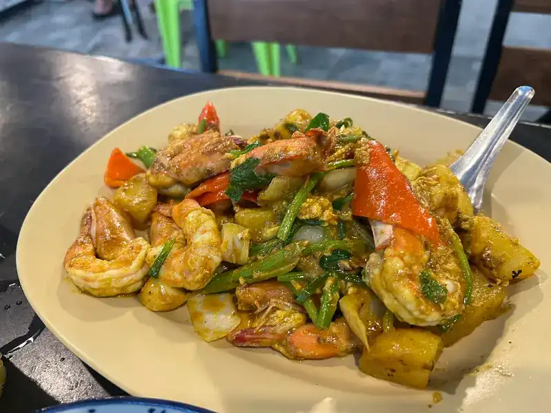 Prawns stir-fried in a yellow curry sauce with spring onion and red chilli / กุ้งผัดซอสกะหรี่สีเหลืองกับต้นหอมและพริกแดง