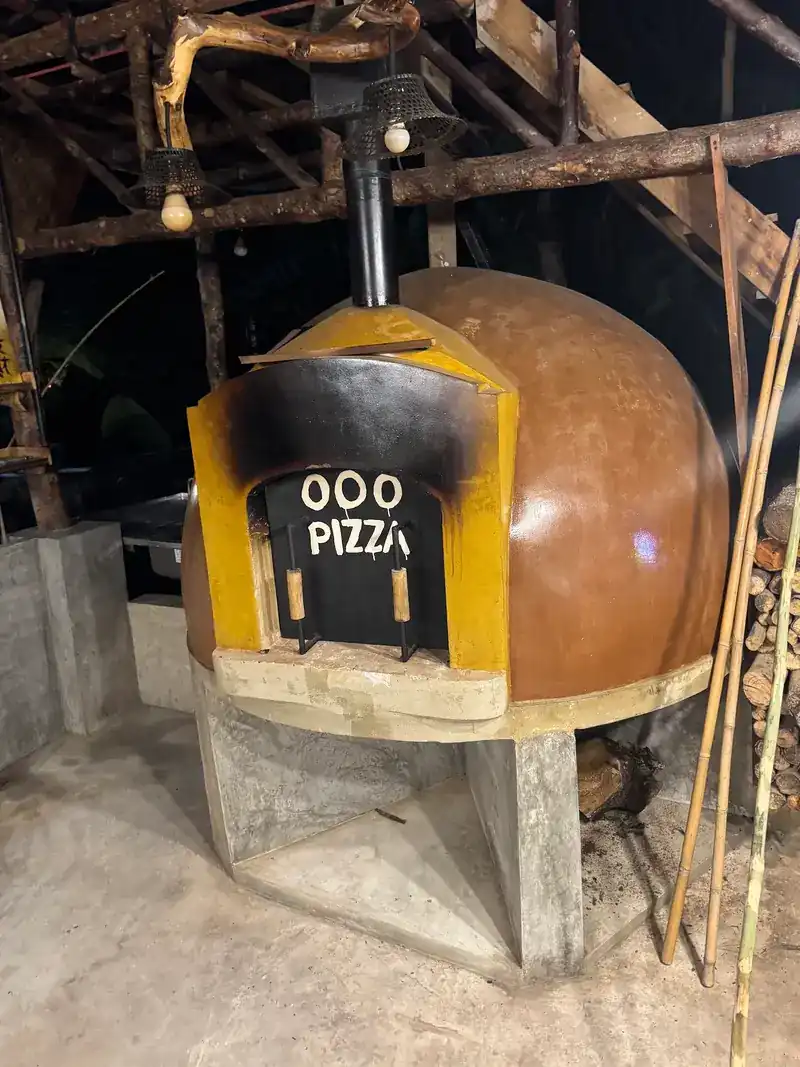The dome pizza oven with OOO PIZZA on its front