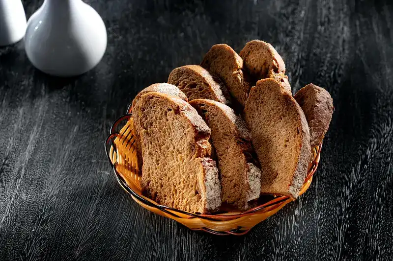 A basket of dark bread slices