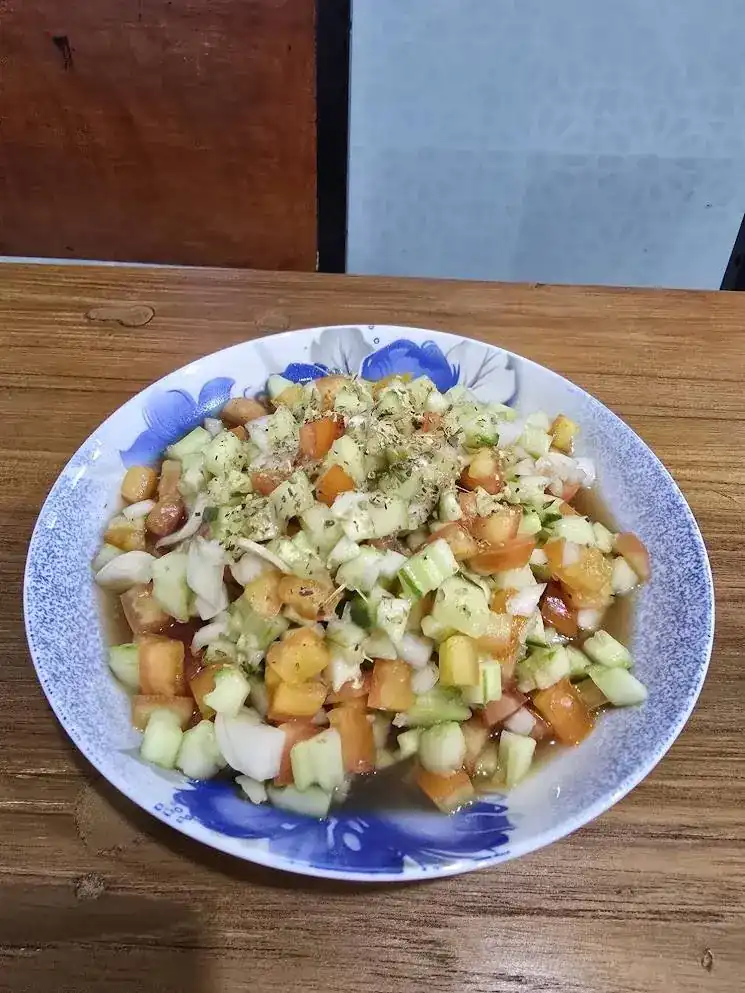 A fresh chopped salad of tomato, cucumber and onion