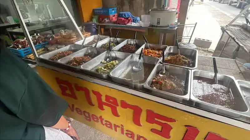 The yellow counter, with steel trays of vegetarian dishes behind the glass