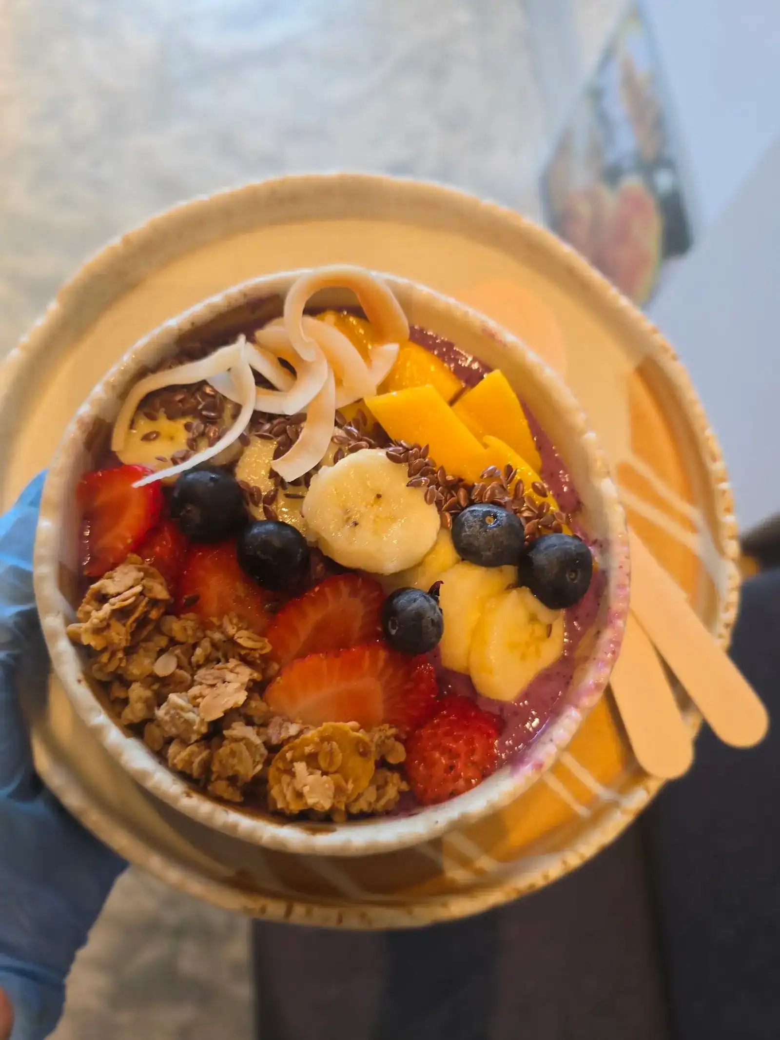 Acai bowl topped with strawberries, blueberries, banana, mango, coconut and granola