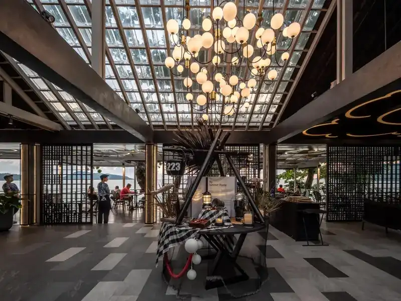 The entrance hall at number 223, under a glass roof and a cluster of globe lamps