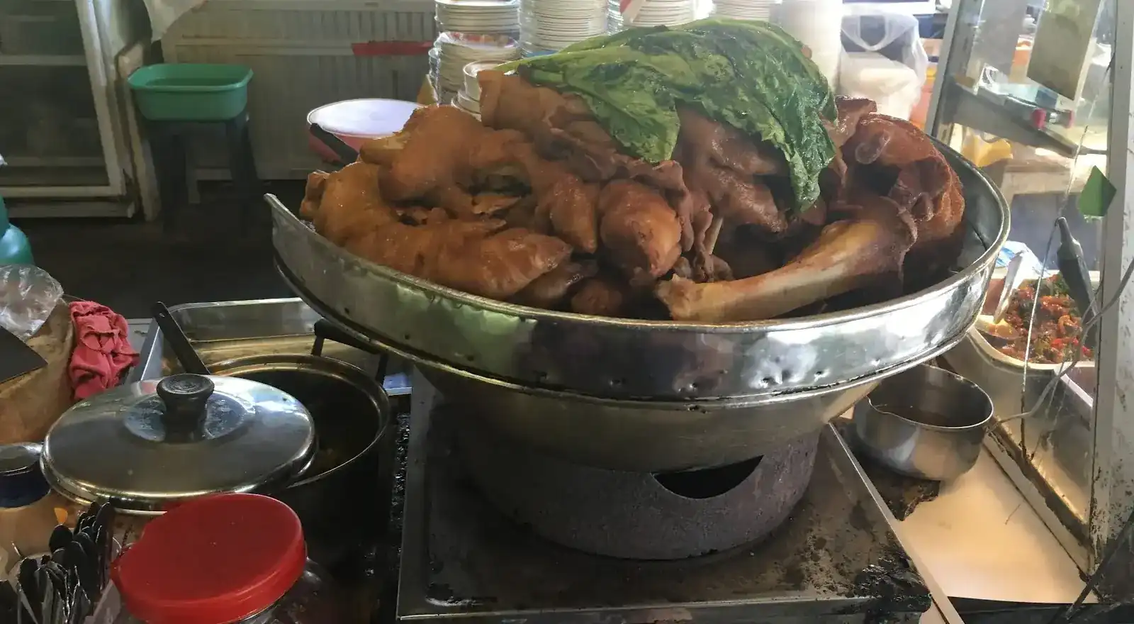 A big pot piled with stewed pork leg on the stove