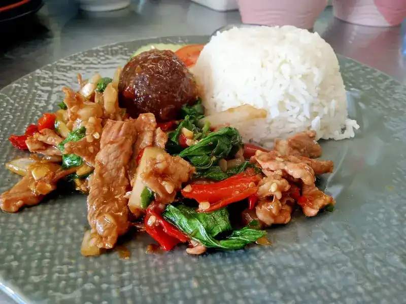 Sliced pork stir-fried with basil and red chilli, served with rice