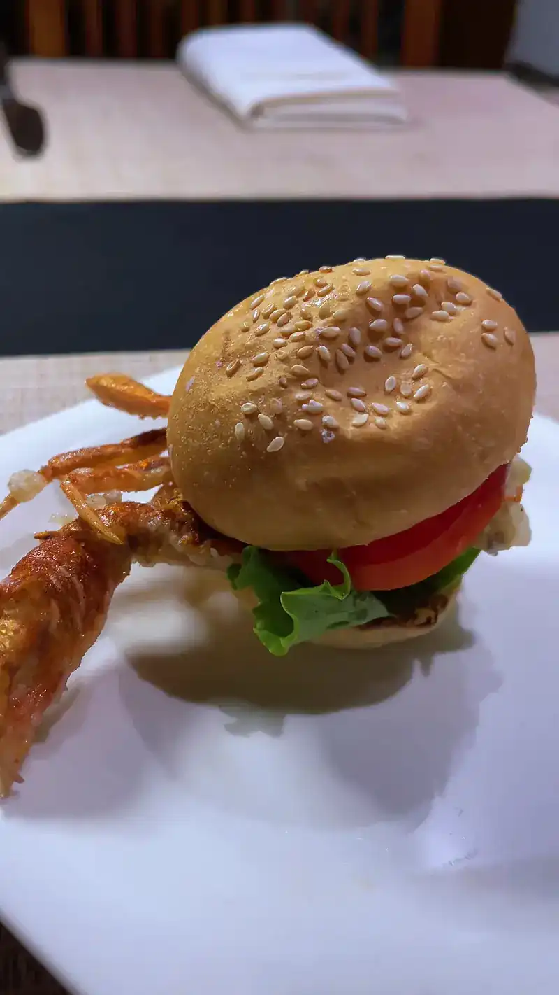 A sesame-bun burger with tomato and lettuce