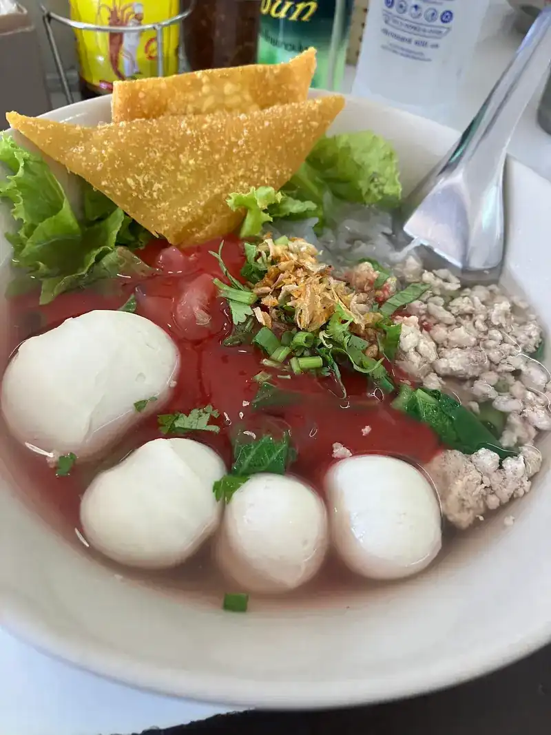 Red sauce noodle soup with fish balls and a crisp wonton sheet