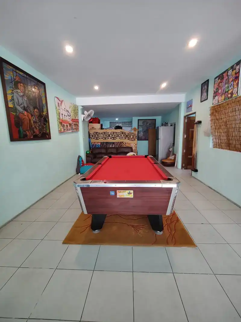 Inside Duke's: mint-green walls hung with colourful paintings, and a pool table with red cloth