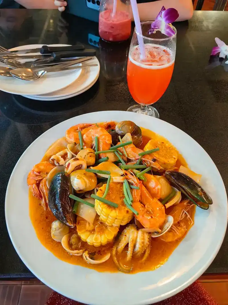 Prawns, mussels, squid, clams and corn in a red sauce