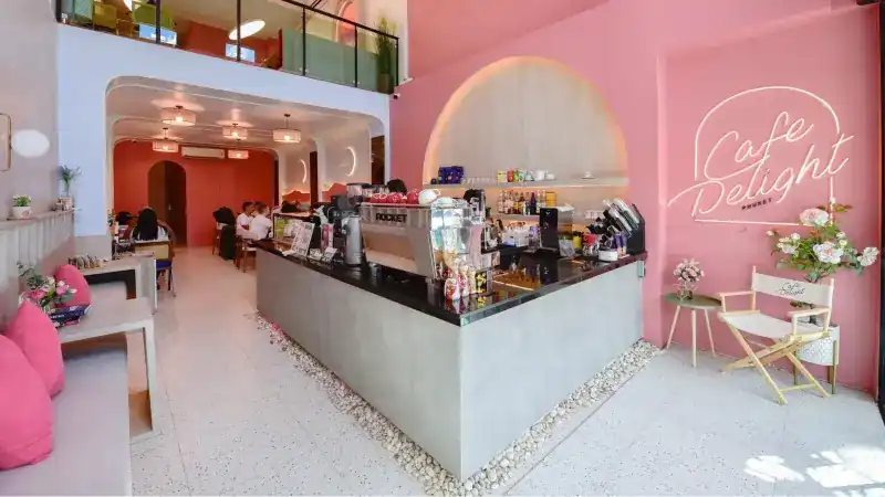 The pink room at Cafe Delight, with the coffee bar in the middle and a terrazzo floor