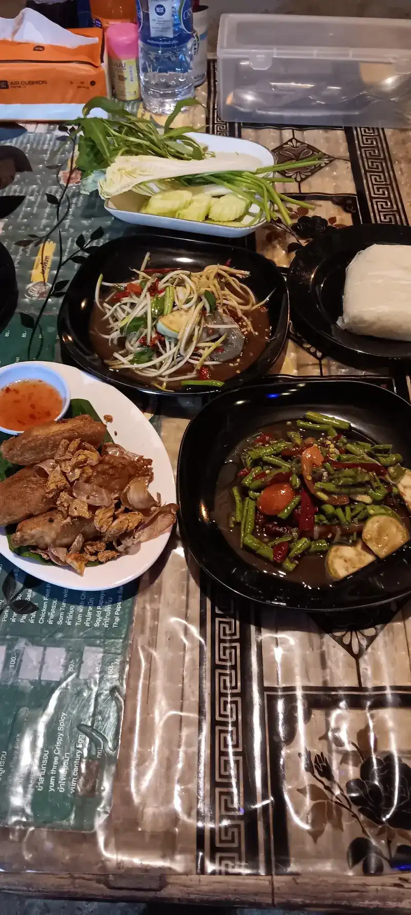 Somtum, grilled pork and other dishes shared on one table