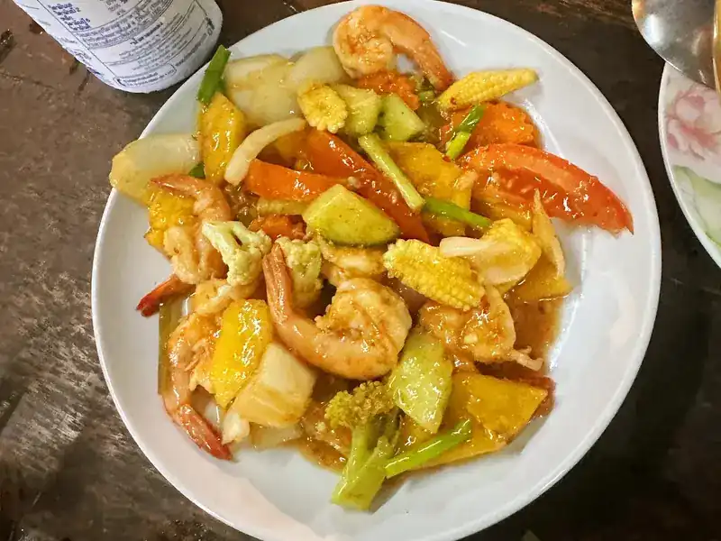 Shrimp stir-fried with pineapple, tomato, cucumber and baby corn in sweet and sour sauce