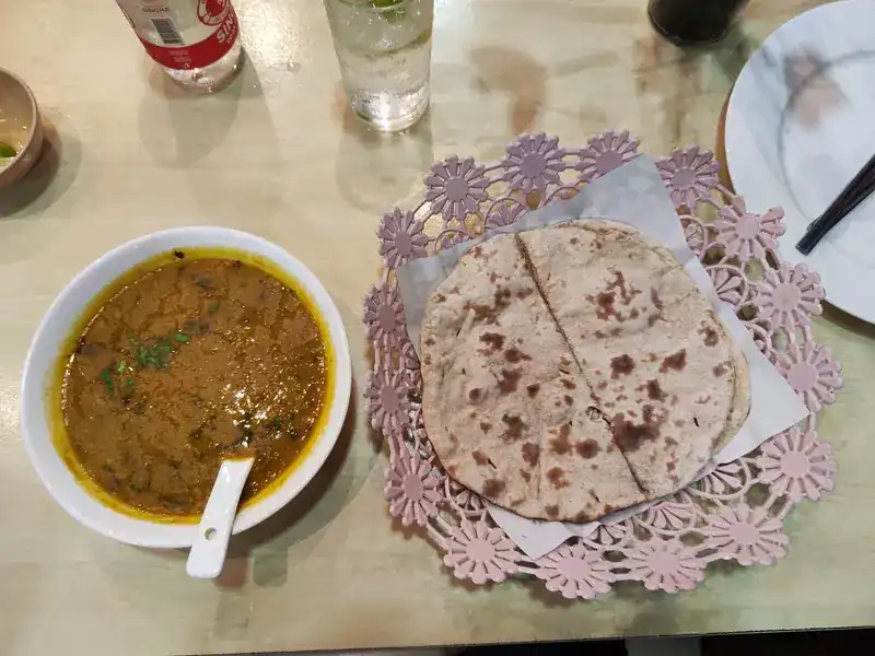 A bowl of curry with roti
