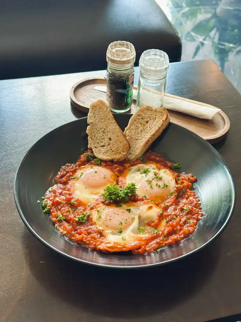 Eggs baked in tomato sauce, with two slices of toasted bread