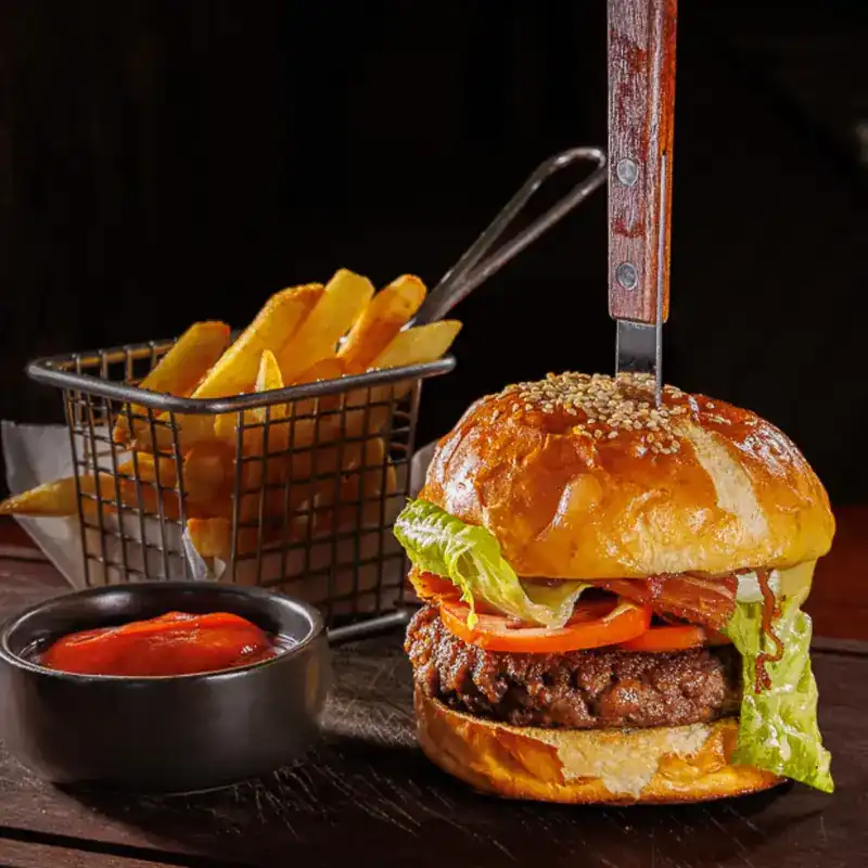Burger with a basket of fries and a dip / เบอร์เกอร์กับเฟรนช์ฟรายส์และซอส