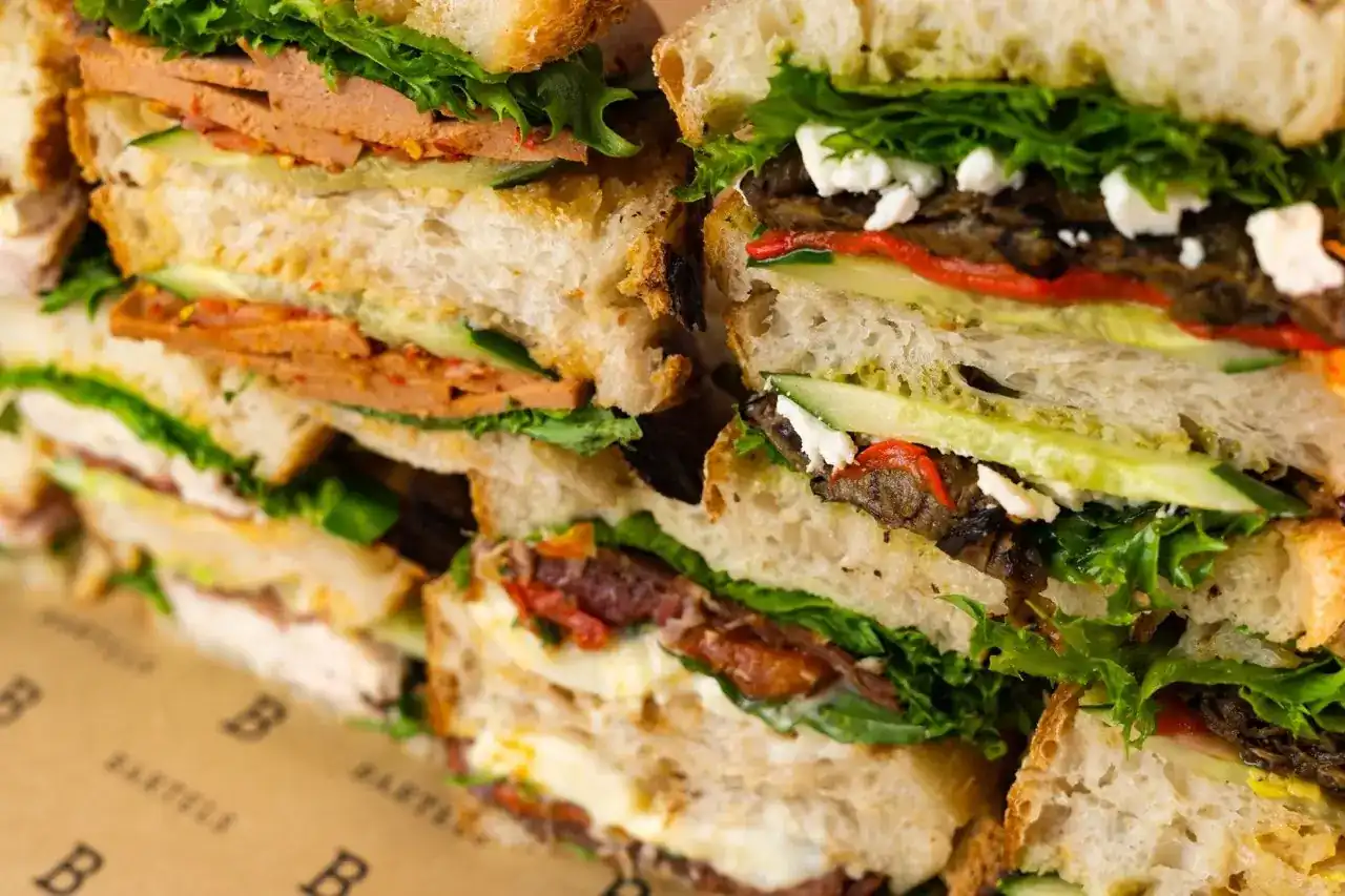 Sourdough sandwiches cut in half and stacked on Bartels wrapping paper