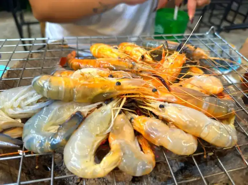 Whole prawns grilling on a wire rack