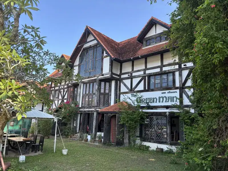 The half-timbered front of The Green Man by day, with the garden in front